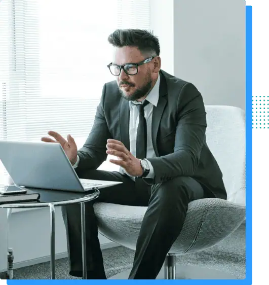 Business professional man in suit working on laptop at modern office desk, technology, corporate productivity, digital workspace, professional environment, Rivell.