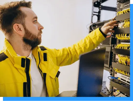 Highly skilled technician inspecting and maintaining network cabling and equipment in a professional server room or data center environment.