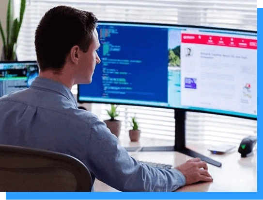 Experienced software developer working on multiple monitors with coding and web development projects at a modern office.
