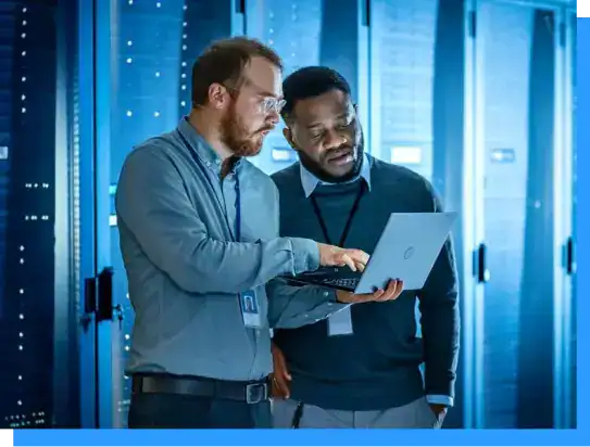 Experienced IT professionals collaborating in a data center with servers, illustrating Rivell's focus on cybersecurity, data protection, and innovative IT solutions for modern businesses.