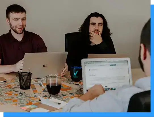 Contemporary business meeting with colleagues discussing projects at a conference table, showcasing teamwork, collaboration, and professional workspace.