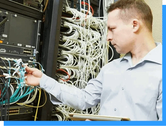 Man working on server rack with network cables and equipment at data center, cybersecurity, IT infrastructure, network management, server maintenance, tech support, Rivell expert.