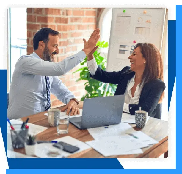 High-five between colleagues in a modern office, celebrating success with teamwork, innovation, and professional collaboration.