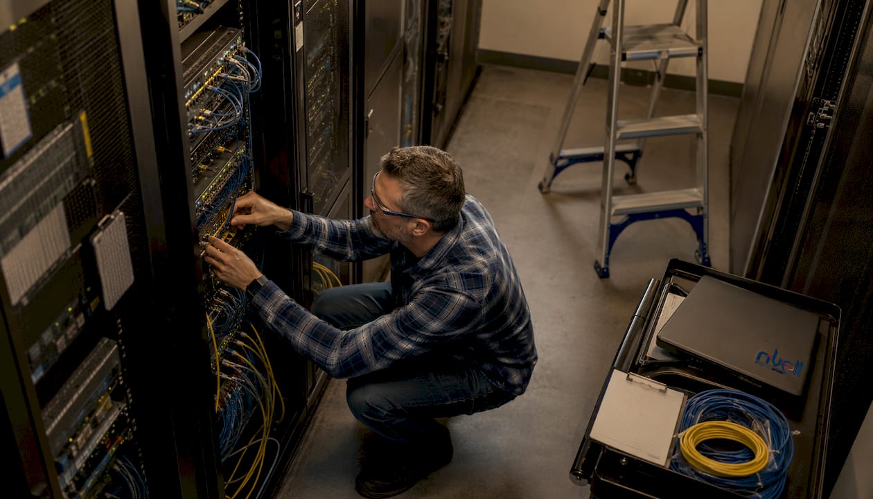 IT engineer working on servers in network room