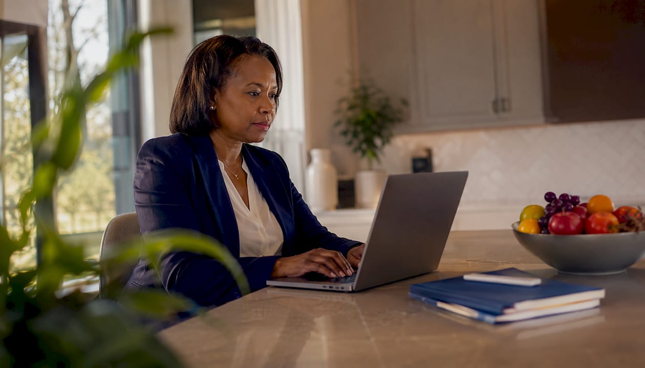Finance specialist at desk working on laptop